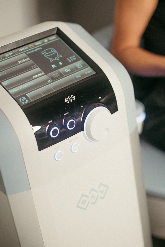 the control panel of an EMSELLA treatment chair at Evolve Aesthetics & Wellness