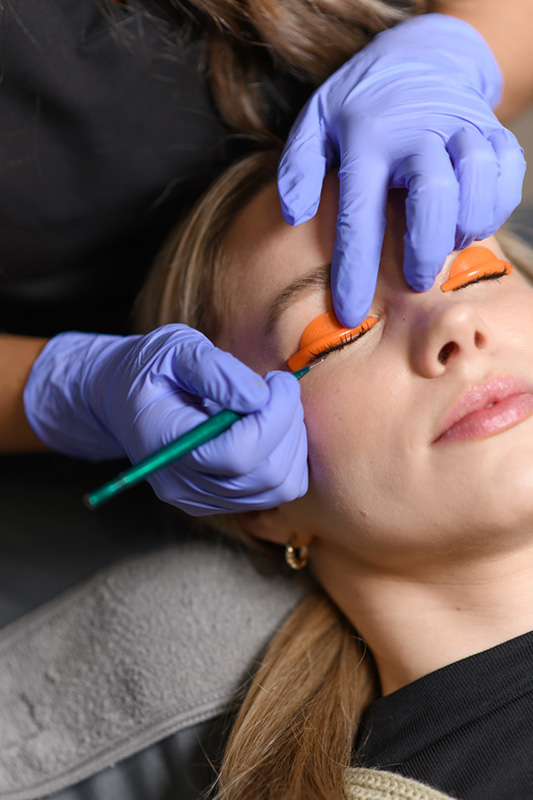 an Evolve Aesthetics & Wellness aesthetician performing a lash lift and tint