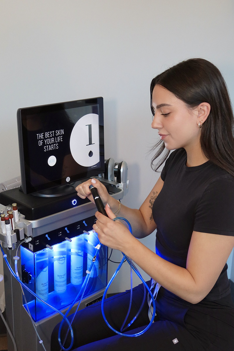 an Evolve Aesthetics team members prepares a HydraFacial treatment
